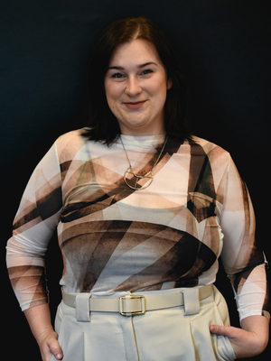 Picture of Bridget standing in front of a black screen